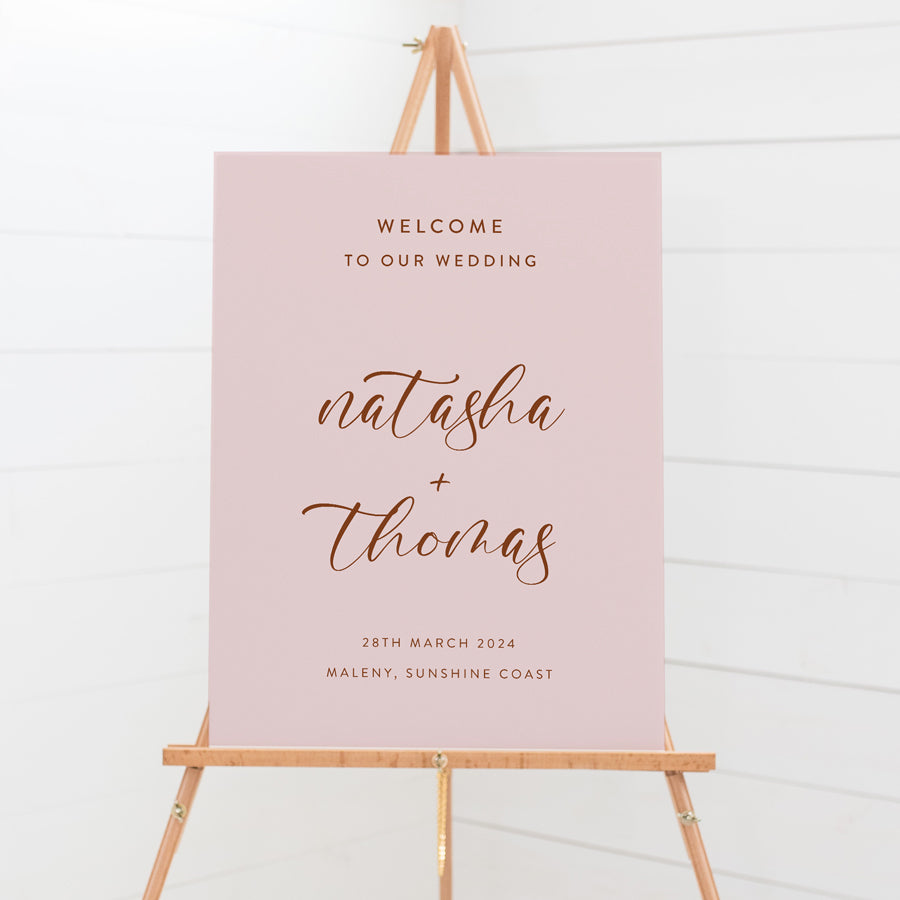 Modern wedding or event welcome sign in soft pink and brownish red or terracotta. Calligraphy text. Peach Perfect Australia.