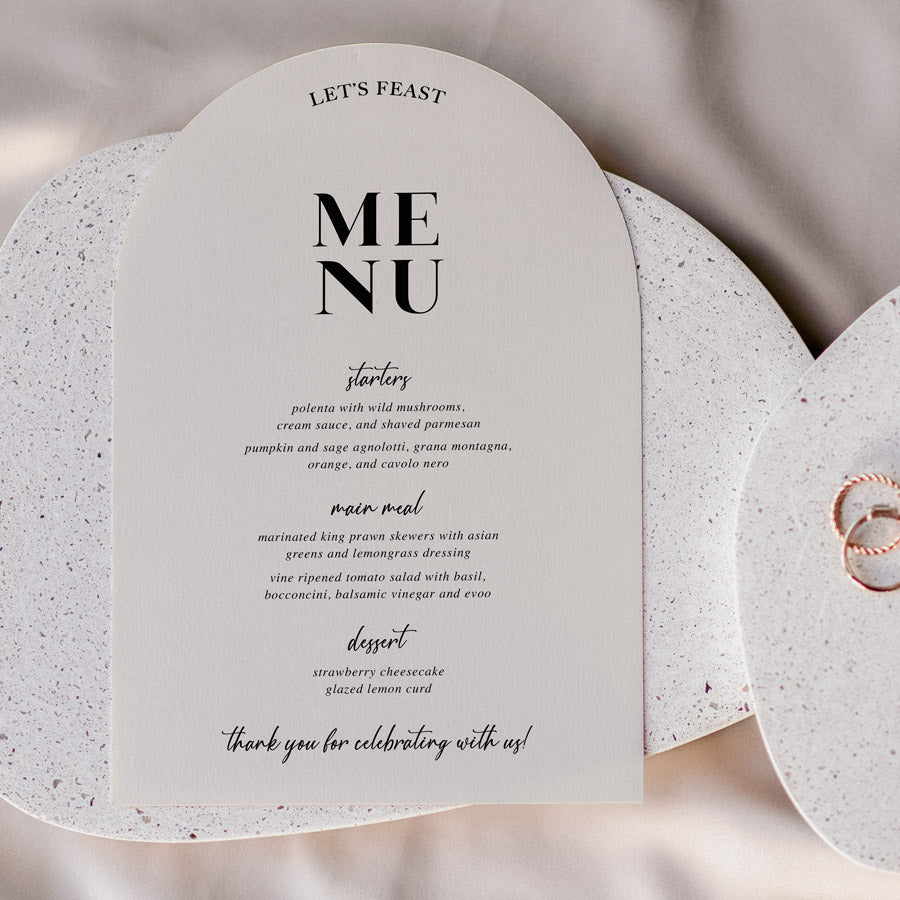 Modern arch wedding menu designed and printed in Australia with calligraphy font. Almond cardstock with Lets Feast for heading.