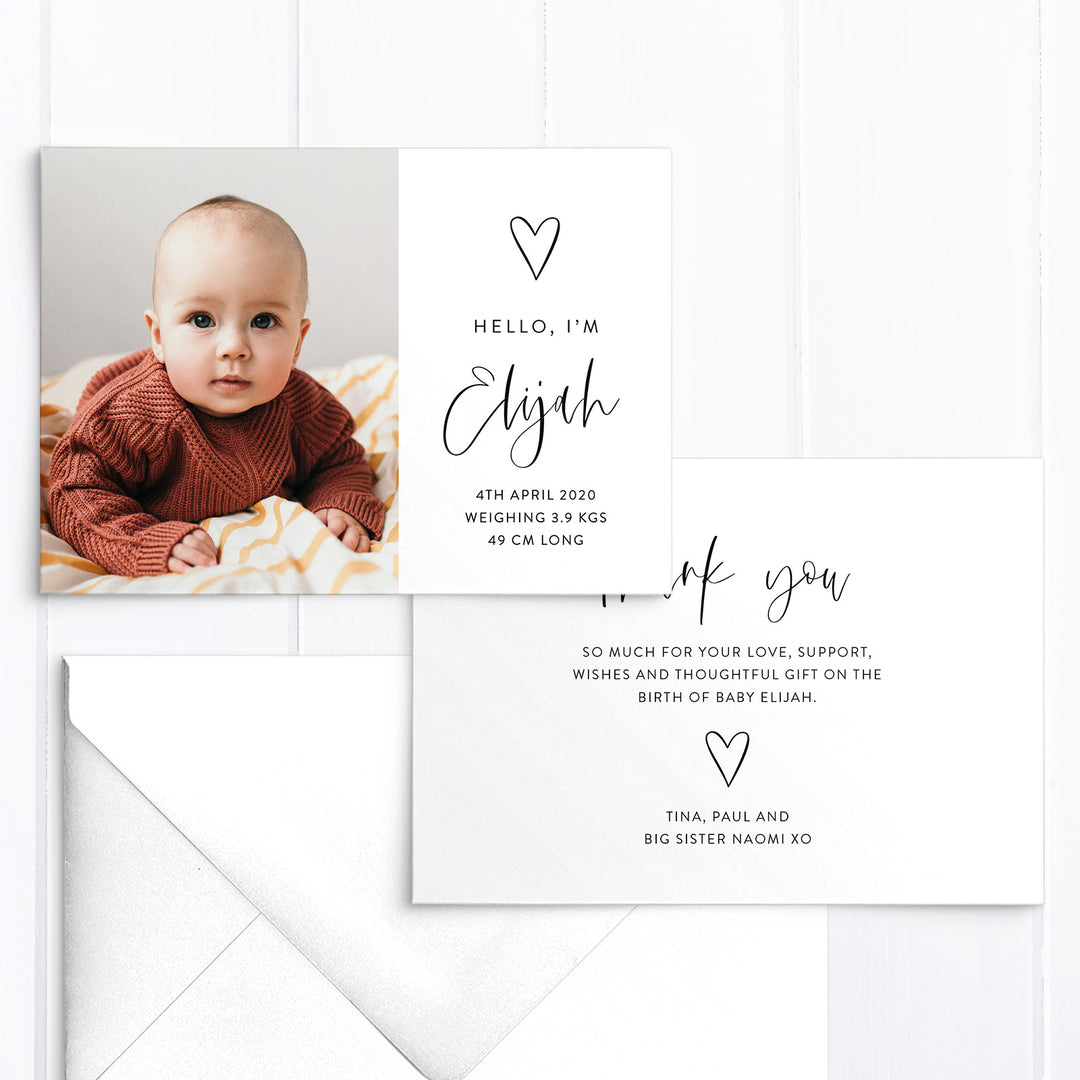 Double sided baby boy photo birth announcement card with large photo of baby, hand drawn love heart and modern script font in black and white