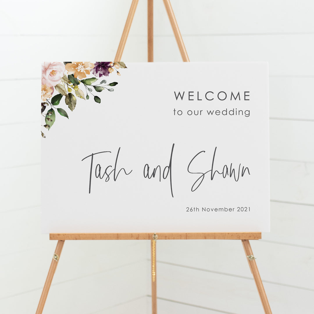 Wedding welcome sign board with watercolour wreath and monogram in neutral colour tones, bohemian style.