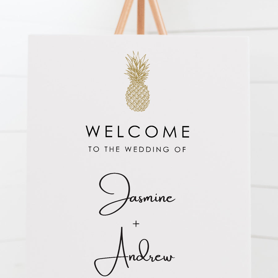 Wedding welcome sign with hand drawn tropical pineapple in gold and modern script font for bride and grooms names