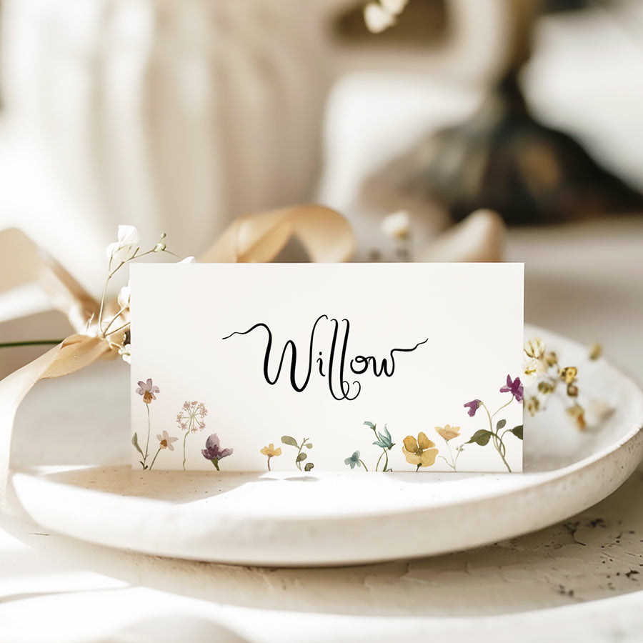Handwritten wedding place cards with wild flowers