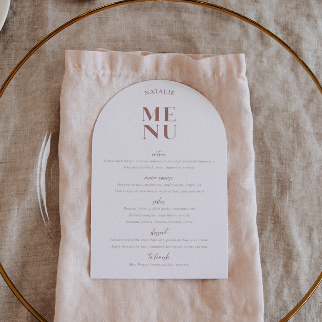 Modern wedding menu in blush pink and white with guest name printing.