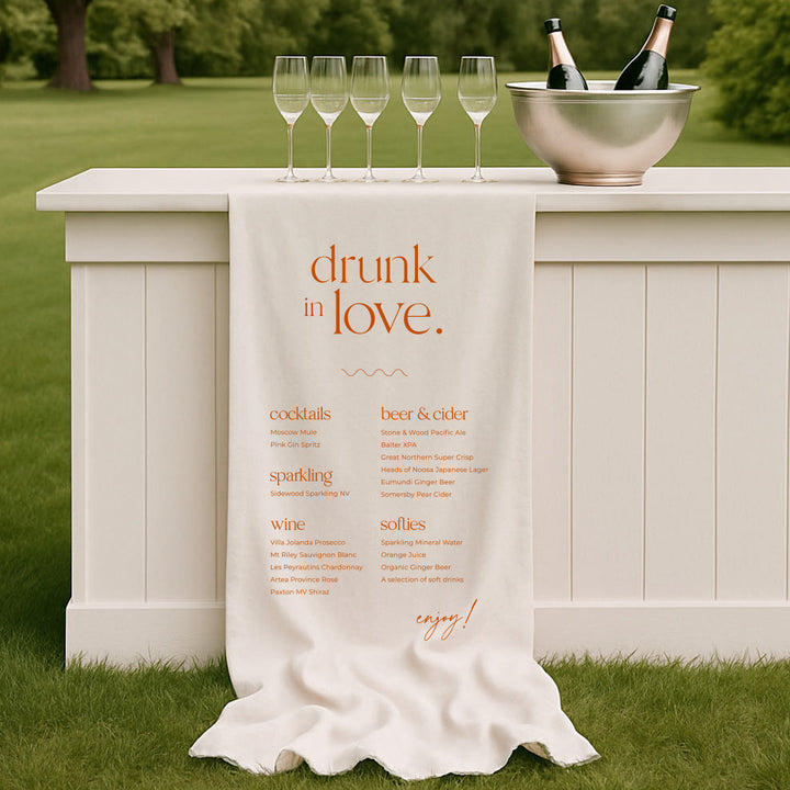 Modern wedding bar sign in burnt orange and white printed on linen or satin. Drunk in Love heading.