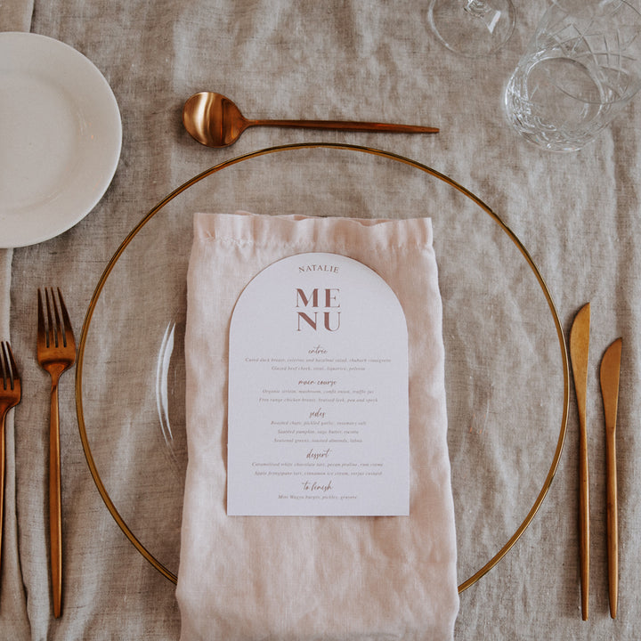 Soft pink and white wedding menu with guest names printed in arch shape