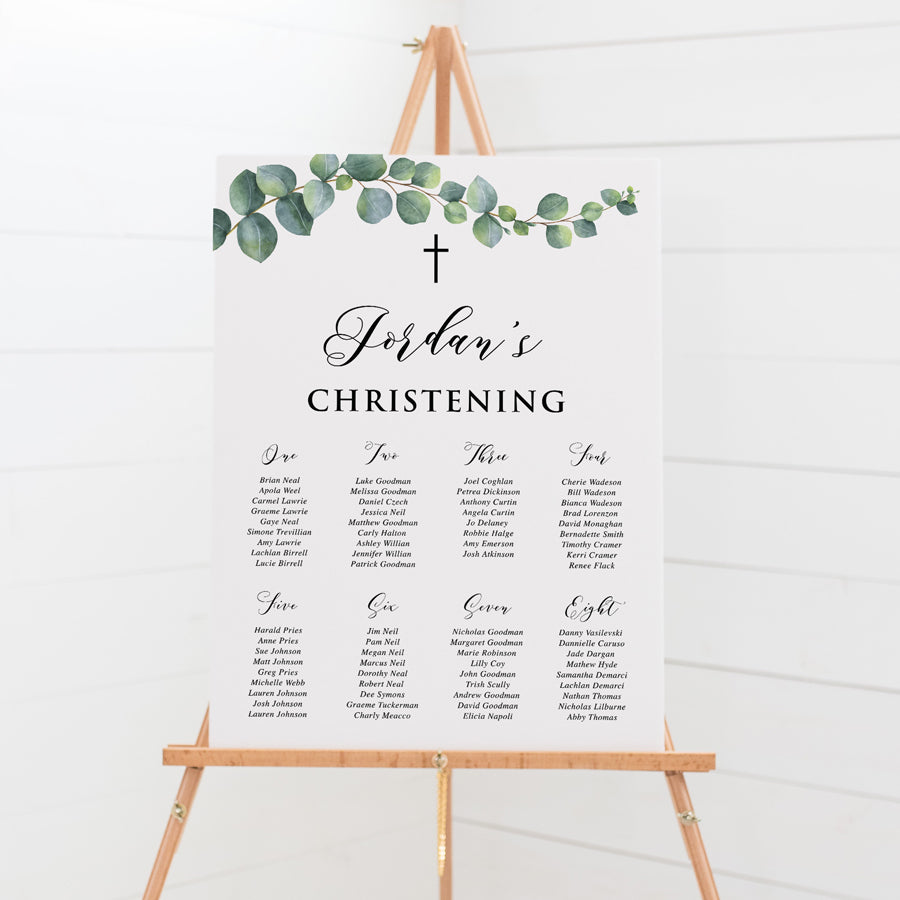 Christening seating plan printed on foamboard with eucalyptus branch and leaves and black text with catholic cross. Peach Perfect Australia.