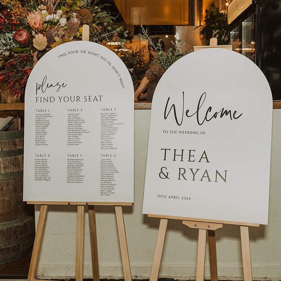 Billie wedding welcome sign and matching seating chart with modern arch shapes, bold typography and contemporary styling.