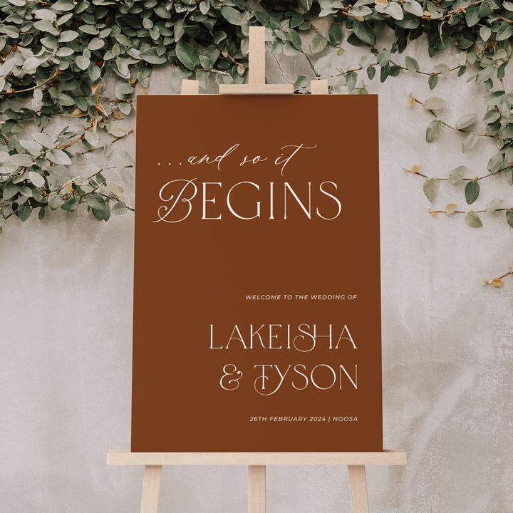 Wedding welcome sign. And so it begins. In rust colour and white printed on signage board or acrylic Australia.