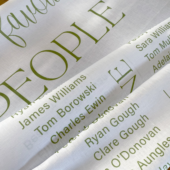 Wedding seating chart close up photo printed on linen fabric in Australia with green text.