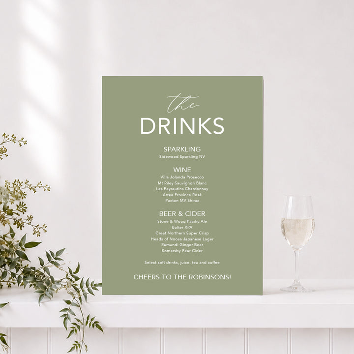 Wedding drinks sign in green and white with "The Drinks" heading and list of alcoholic drinks, printed on foamboard or acrylic in Australia.