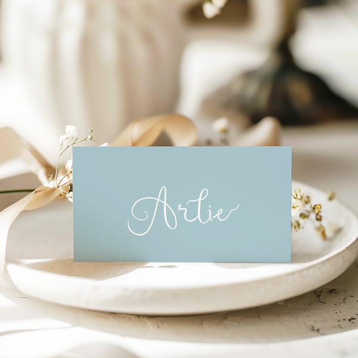 Folded wedding place card or name cards with hand written script font in blue and white. Peach Perfect Australia.