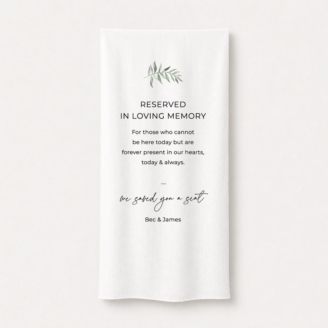 A white draped fabric memorial banner or fabric sign with elegant black text reading &