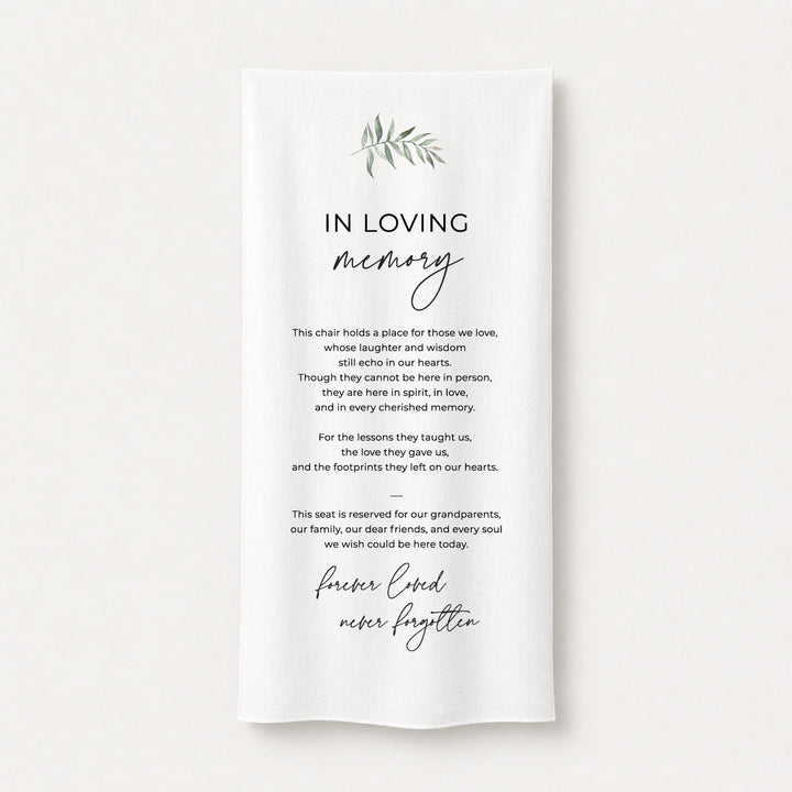 A white draped fabric memorial banner or fabric sign with elegant black text reading &