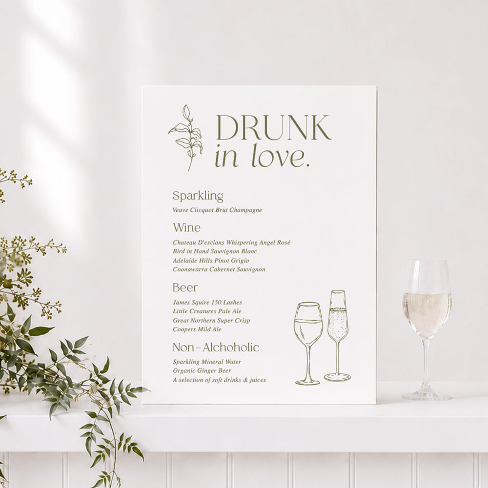 Renee wedding bar or drinks sign with "Drunk in Love" heading in green and white and line art drawings of champagne glass.