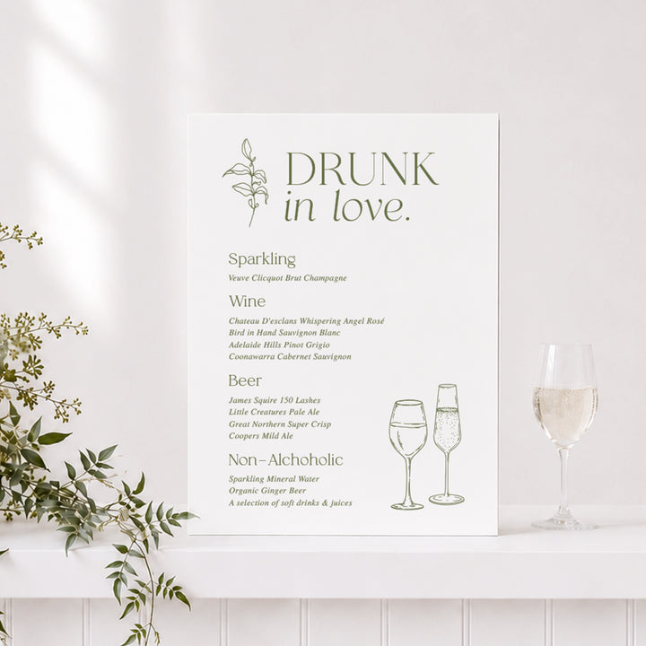 Renee wedding bar or drinks sign with "Drunk in Love" heading in green and white and line art drawings of champagne glass.