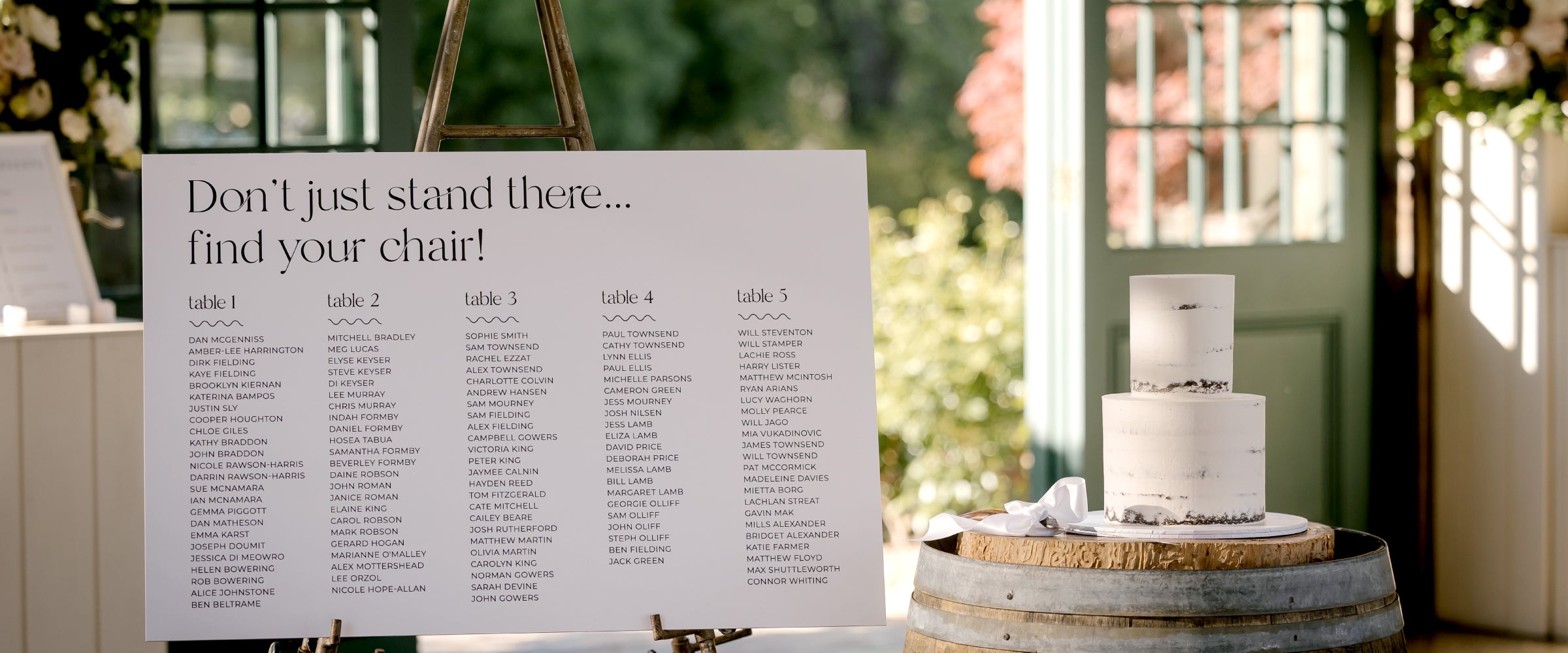 Modern wedding seating chart in black and white with. heading 'Dont just sit there find your chair'