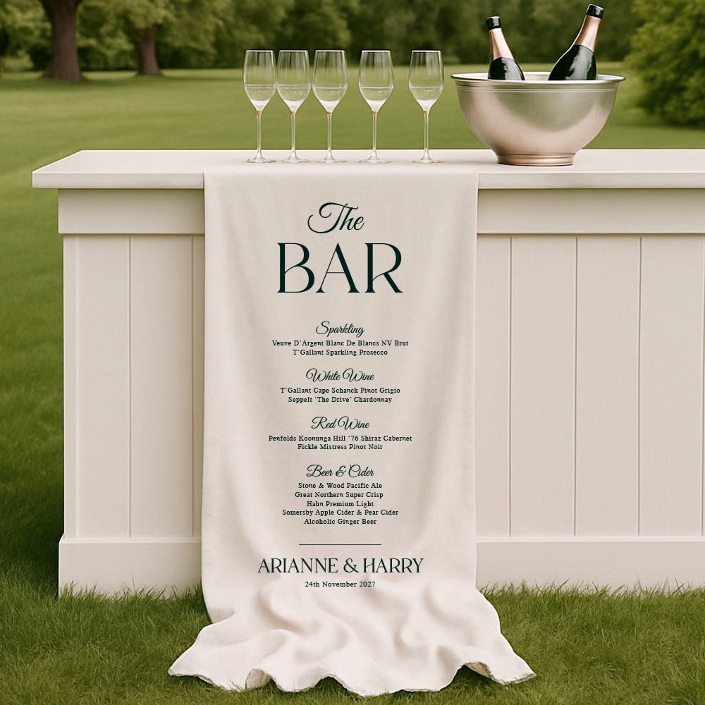 Fabric wedding bar sign draped over a white bar displaying a classic drinks menu with elegant serif typography. Designed and printed in Australia.