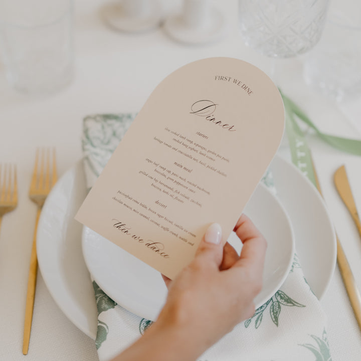 Romantic wedding menu printed on almond cardstock with first we dine, then we dance heading in arch shape.