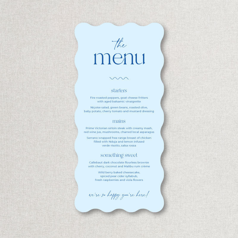 Light blue wedding menu in wavy die cut shape with blue text. Printed by Peach Perfect Australia.