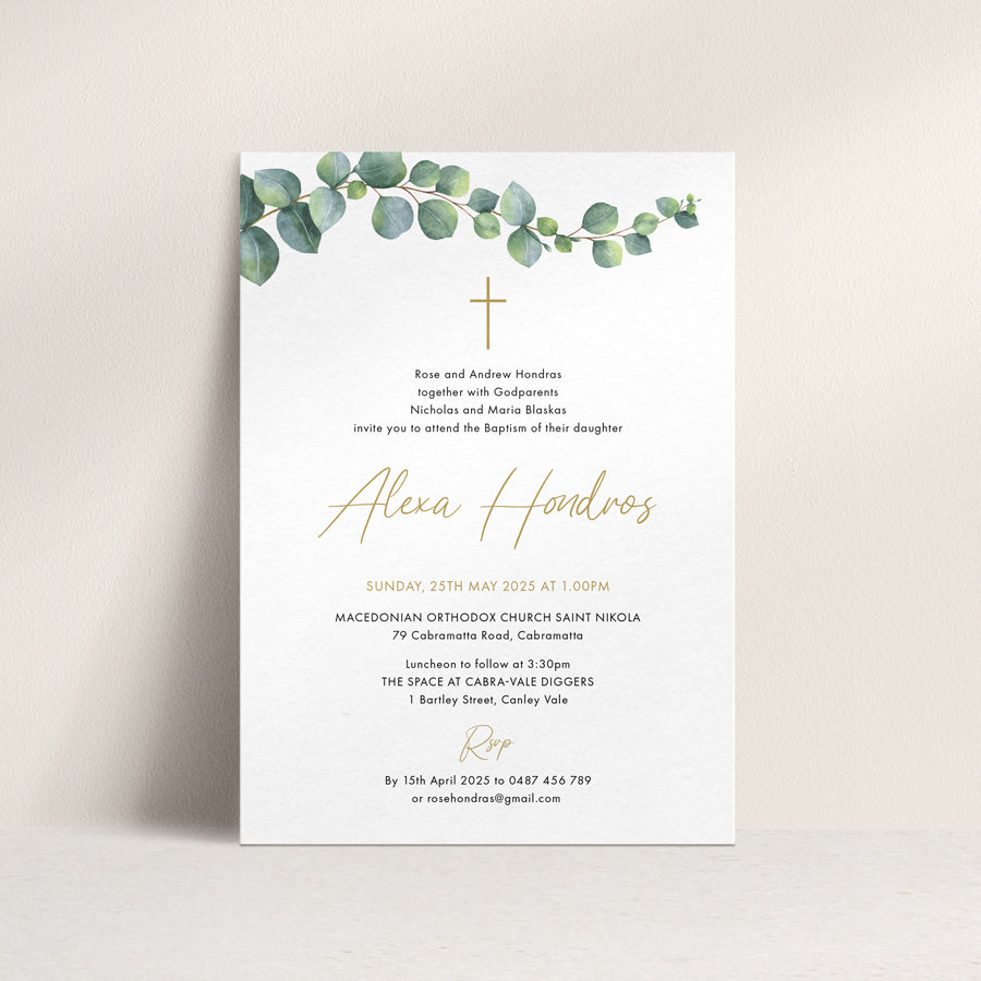 Baptism or Christening invitation with trailing eucalyptus vine, calligraphy font, catholic cross in gold and black. Peach Perfect Australia.