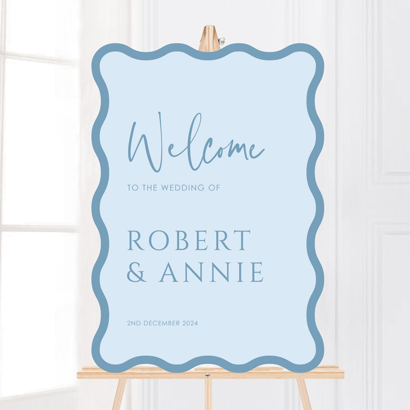 Modern wave shape wedding welcome sign in pale blue, printed on foamboard or acrylic. Peach Perfect Australia. 