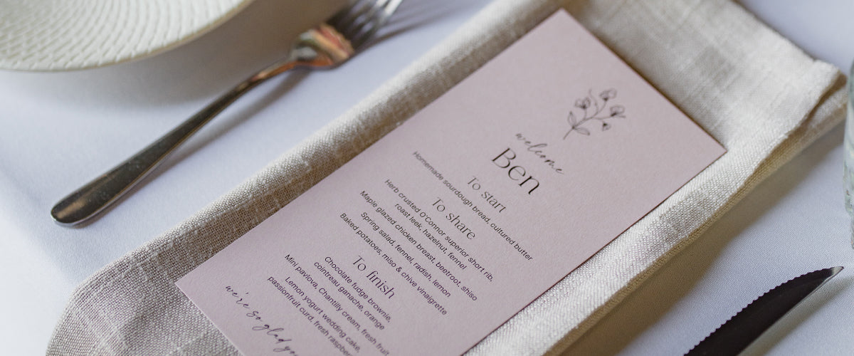 soft pink wedding menu with line art floral design and guest name printing