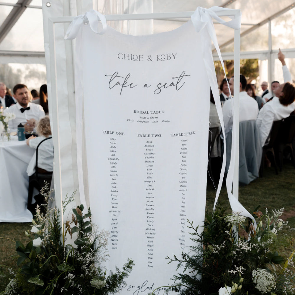 Wedding seating chart printed on premium linen fabric in Australia with three tables in black ink. 