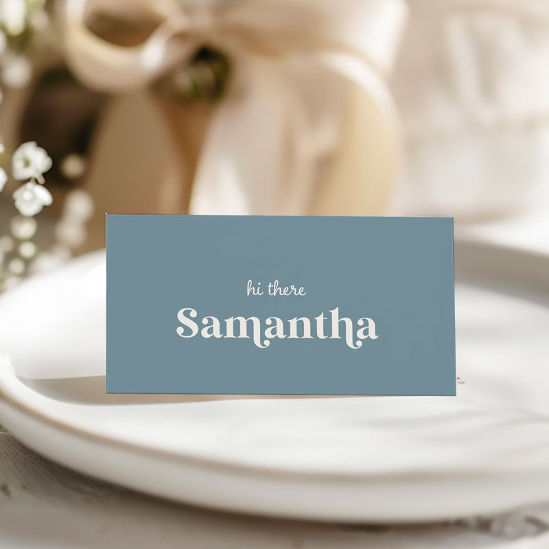 Folded or flat wedding place card printed on blue card with white text by Peach Perfect Australia
