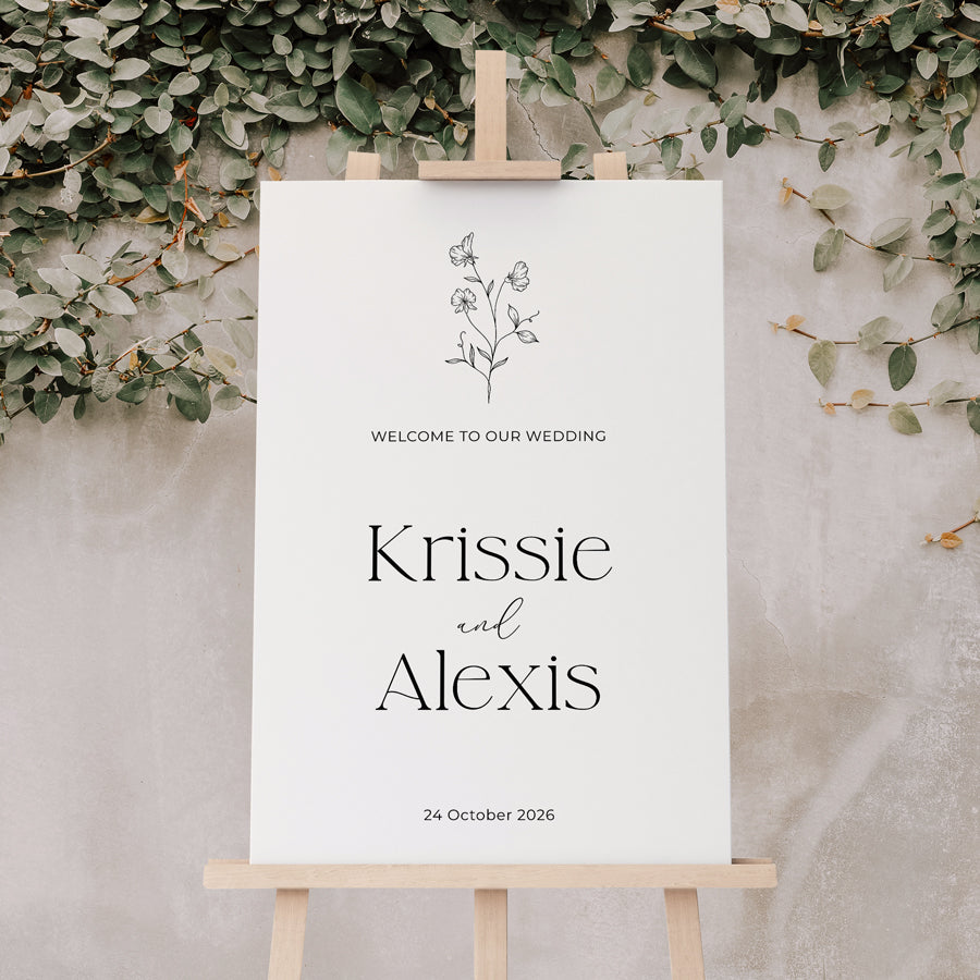 Wedding welcome sign with floral design and calligraphy in black and white