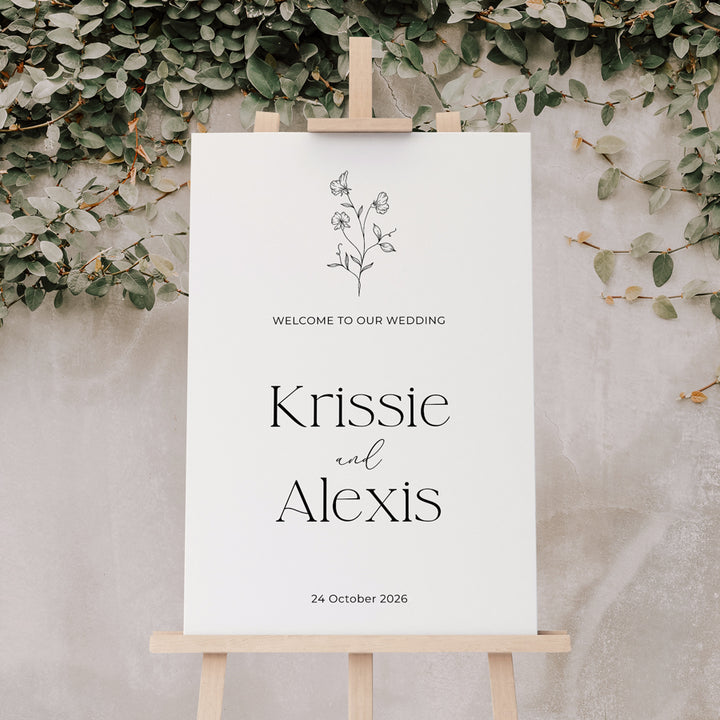 Wedding welcome sign with floral design and calligraphy in black and white