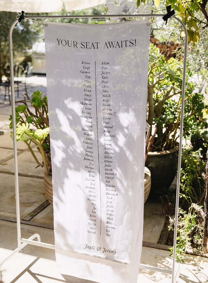 Linen wedding seating chart with your seat awaits heading