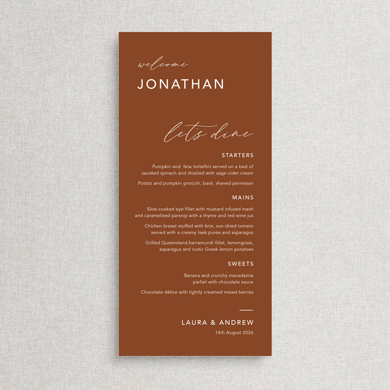 Modern wedding menu on terracotta card with white ink and guest names. Lets dine heading. Printed in Australia.