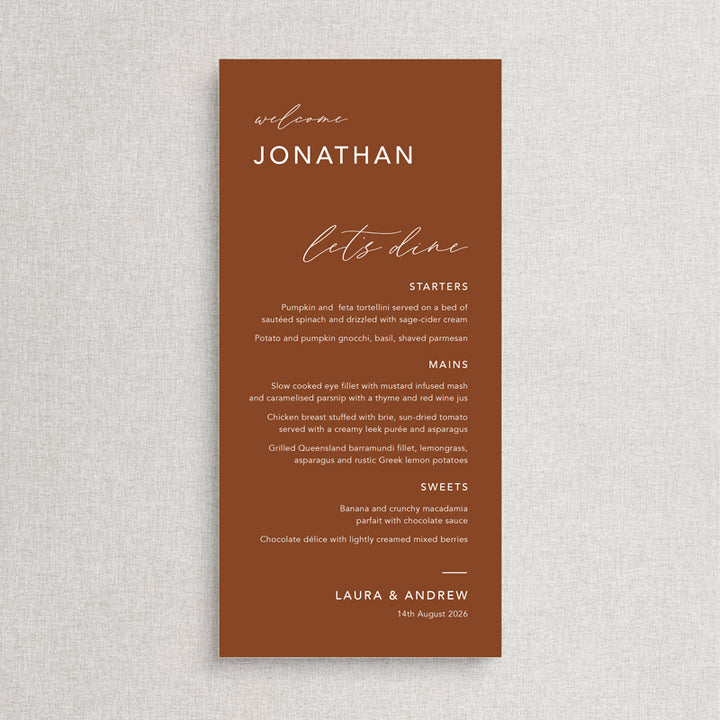 Modern wedding menu on terracotta card with white ink and guest names. Lets dine heading. Printed in Australia.