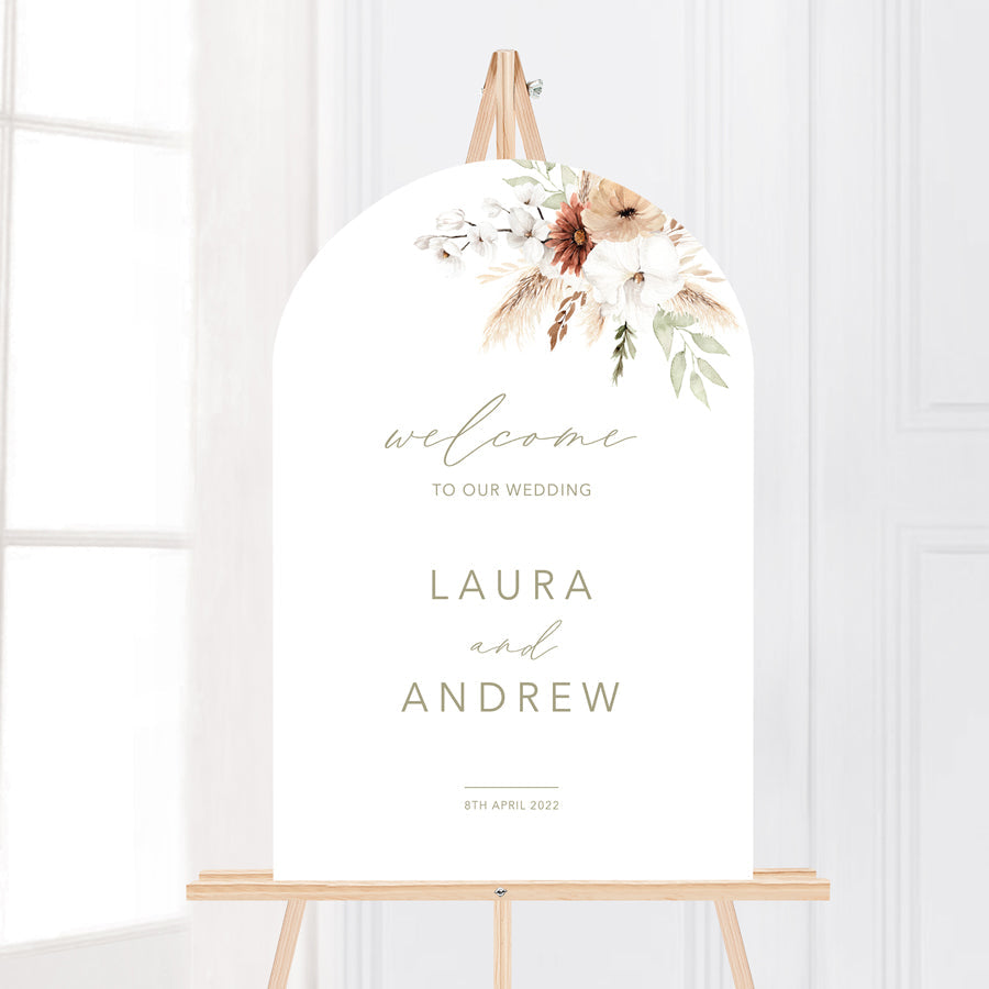 Modern arch shape wedding welcome sign board with boho florals and calligraphy.