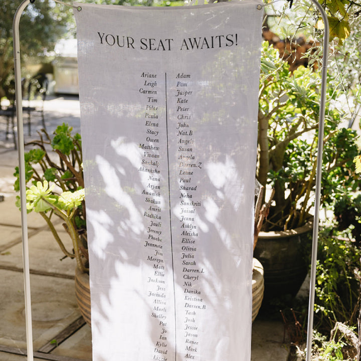 Wedding seating chart printed on premium linen fabric in Australia with three tables in black ink. 