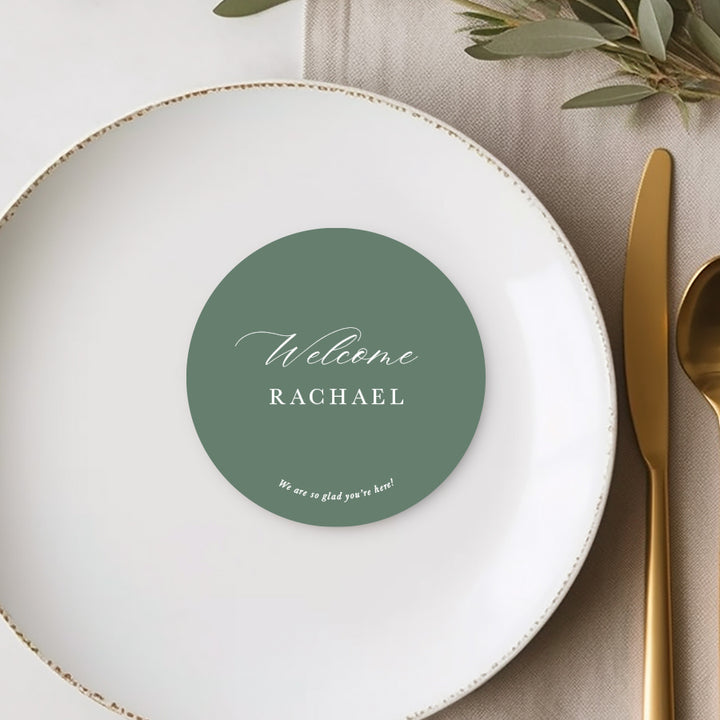 Die cut round wedding place cards or name cards with calligraphy font and personalised message to guests. White ink on green card.
