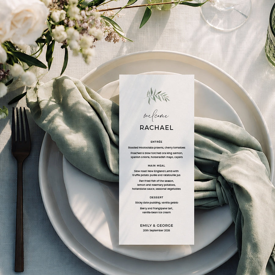 Natural wedding menu with watercolour leaf in green and guest names printed on white cardstock.