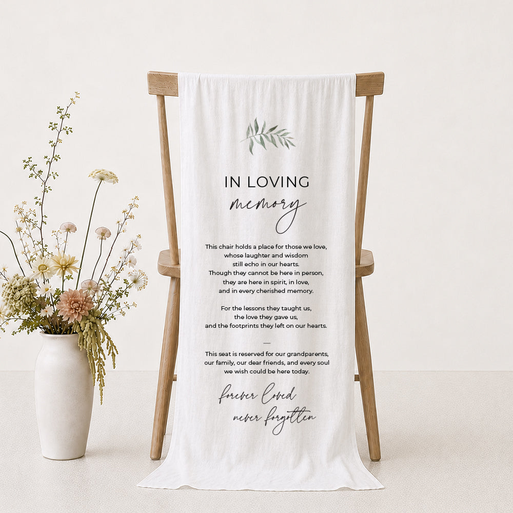 A white draped fabric memorial banner or fabric sign with elegant black text reading &