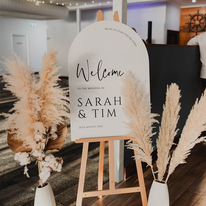 Beautiful arch shape wedding welcome sign in black and white with boho decorations