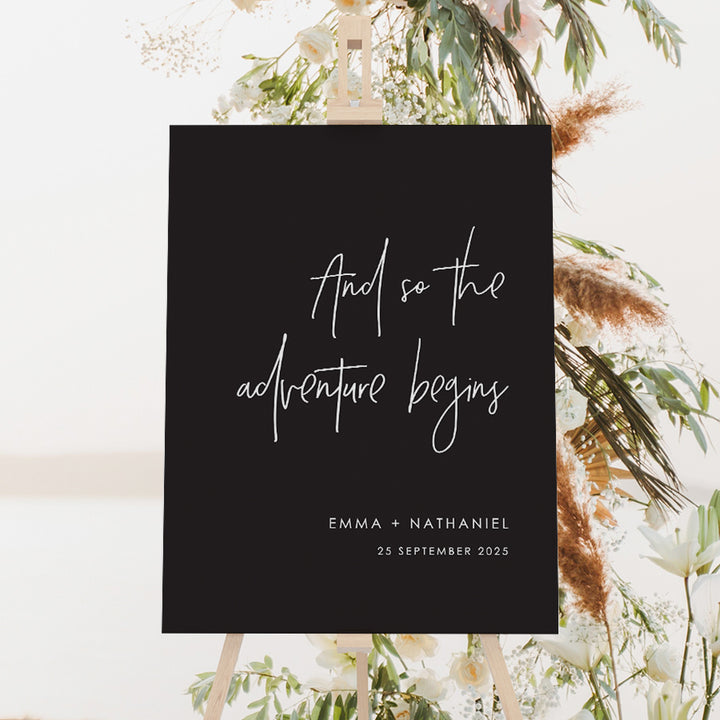 Black wedding welcome sign with wording and so the adventure begins. Designed and printed in Australia on foamboard or acrylic.