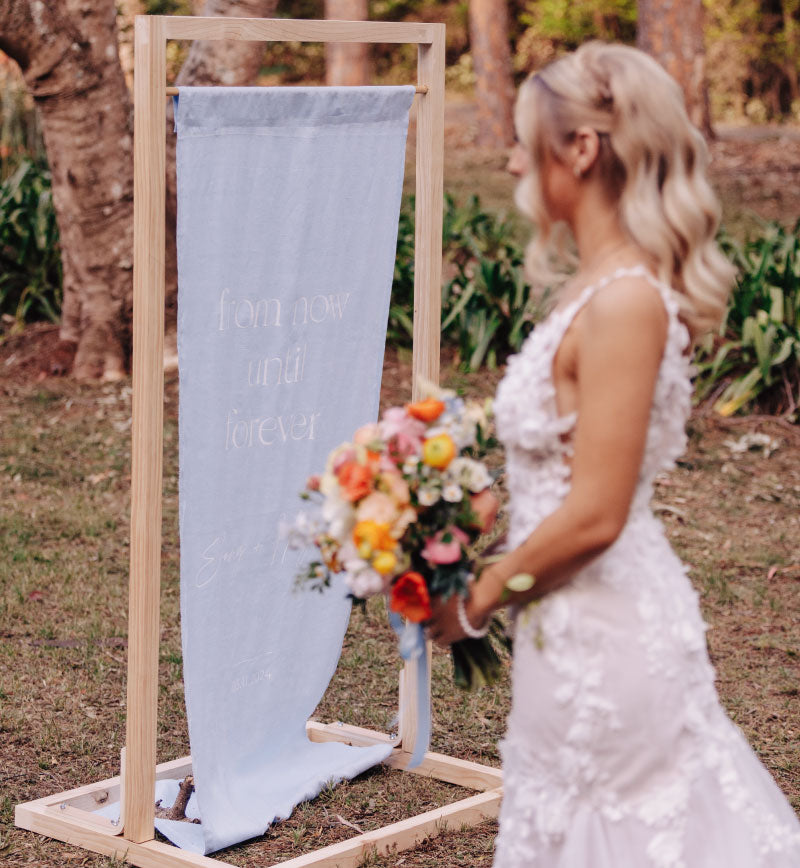 Light timber Wedding Sign Stand Hire for linen fabric signage Sunshine Coast and Brisbane