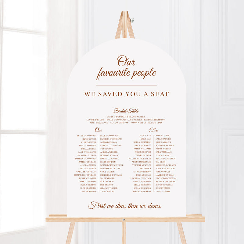 Wedding welcome sign on an easel printed on foamboard or acrylic in arch shape. Timeless calligraphy style.