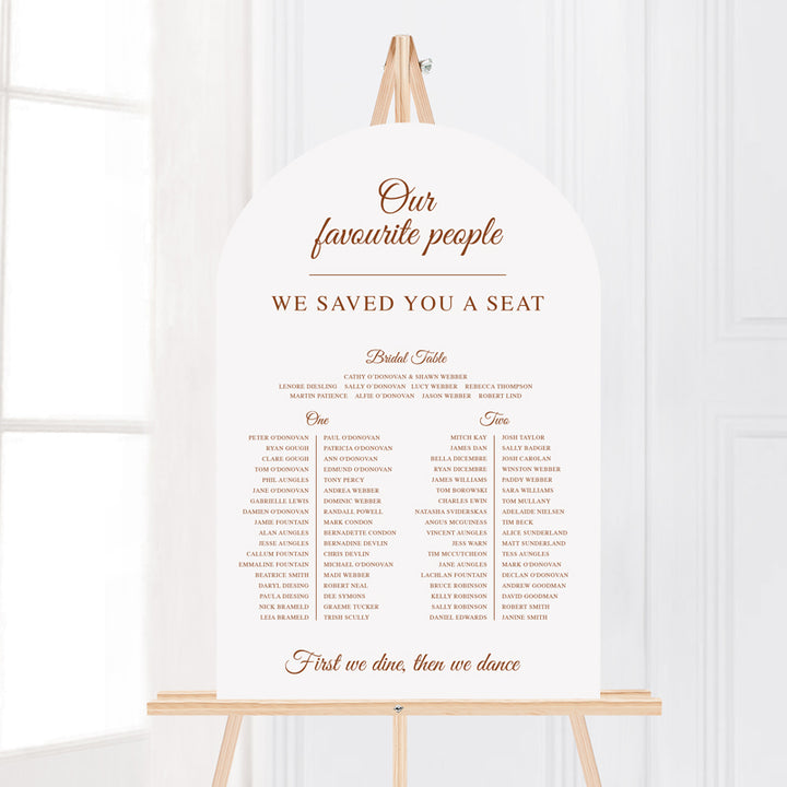 Wedding welcome sign on an easel printed on foamboard or acrylic in arch shape. Timeless calligraphy style.