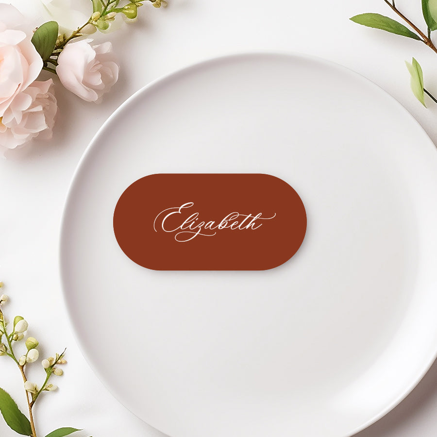 Rounded flat wedding place cards with calligraphy font in terracotta red and white. Designed and printed in Australia.