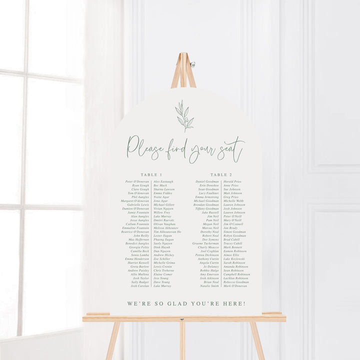 Wedding seating chart on foam board in neutral green and white with hand drawn leaf element. Arch shape. Peach Perfect Australia.