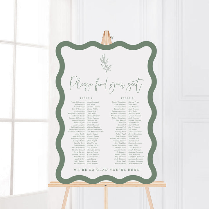 Wave or wiggle shape wedding seating chart in green and white with hand drawn leaf element. Peach Perfect Australia.