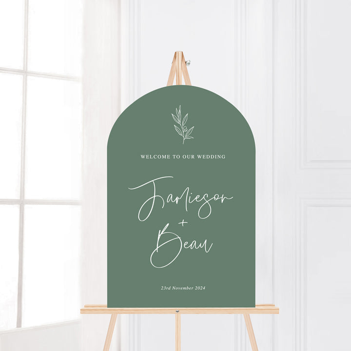 Arch wedding welcome sign on foamboard or acrylic with hand drawn olive leaf, green background white text. Printed in Australia.
