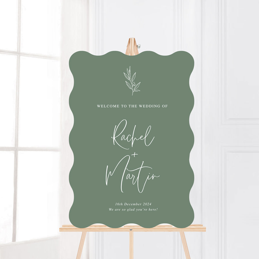 Wavy wiggle shape wedding welcome sign on foamboard or acrylic with hand drawn olive leaf, green background white text. Printed in Australia. 
