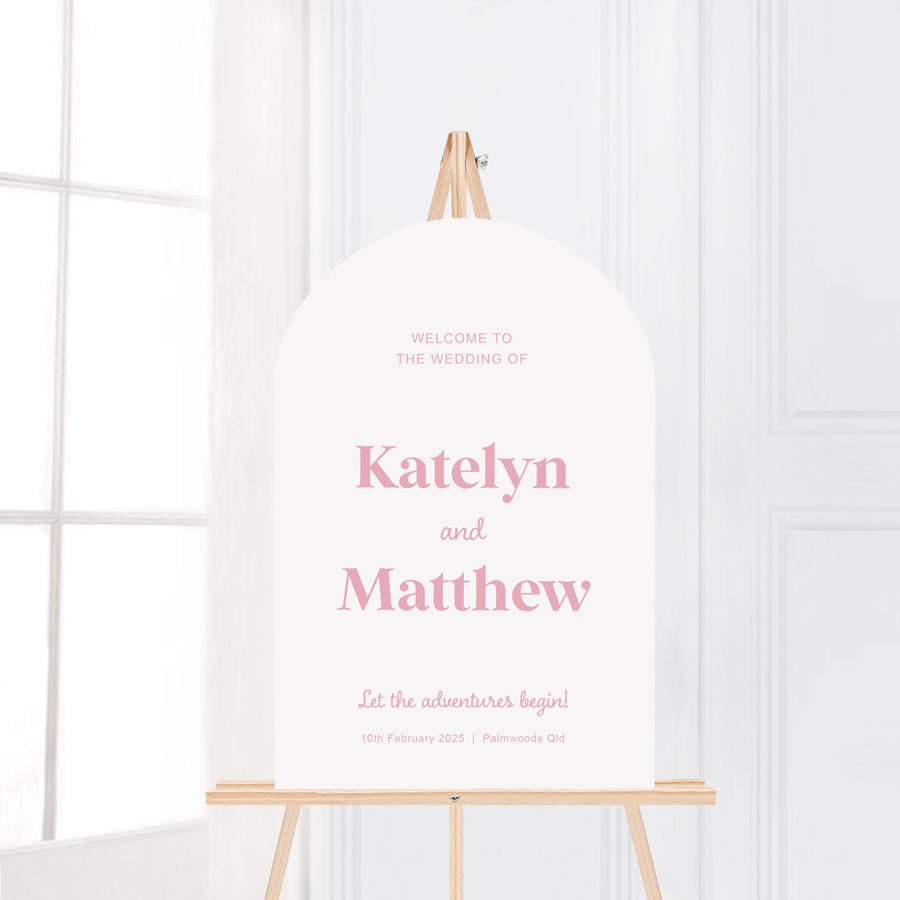 Modern retro font wedding welcome sign printed in Australia. Let the adventures begin. Pink and white arch shape.