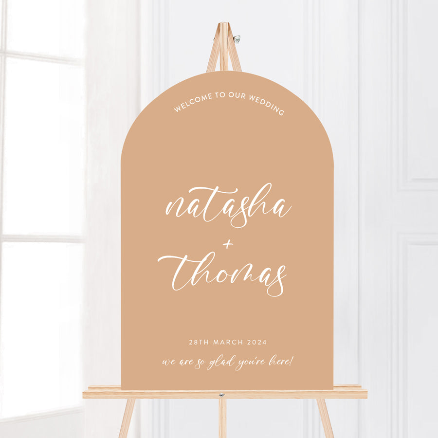 Arch wedding welcome sign in cinnamon or terracotta and white text. Calligraphy text and hashtag. Peach Perfect Australia.